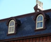 Detailed view of the bonnetted dormers located on the quadreplex, Devon Row, St. John's.  Note the original elaborate scrollwork.; Deborah O'Rielly/ HFNL 2007