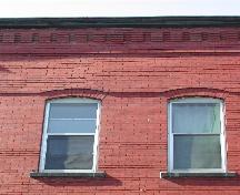This photograph shows the roof-line cornice and the proportions of the windows that are used throughout the 2nd and 3rd floor, 2004; City of Saint John