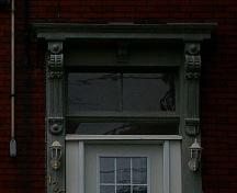 This image shows Italianate detailing in the entranceway above door, the transom and the entablature; City of Saint John
