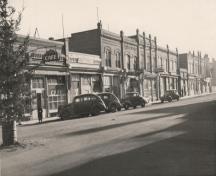 Archival view, from the northwest, of the Forbes Building (right, behind the car), Carberry, 1944; Carberry Plains Archives, 1944