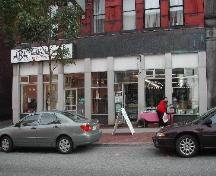 This photograph shows the storefront with the large fascia band and heavy pillars, 2004.; City of Saint John