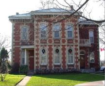 Of note are the two storey, polychromatic, brick exterior and the low hip roof with centre gable.; City of Brantford, n.d.