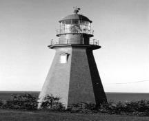 General view of the Lighthouse, showing the well-proportioned eight-sided tower divided into three sections, 1980.; Canadian Transportation Agency, Canadian Coast Guard / Office des transports du Canada, Garde côtière canadienne, NLF 1657, 1980.