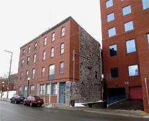 The building which shelters Crow's Nest, on Water street. The club is located on the fourth floor of the joint building on the right-hand side; Parks Canada / Parcs Canada, 2010 (Nicolas Miquelon)