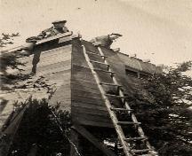 Picture showing brothers Eric and Craig Dawe dismantling the watch tower on the Dawe Property. Photo taken post World War Two.; © Eric Dawe 2010