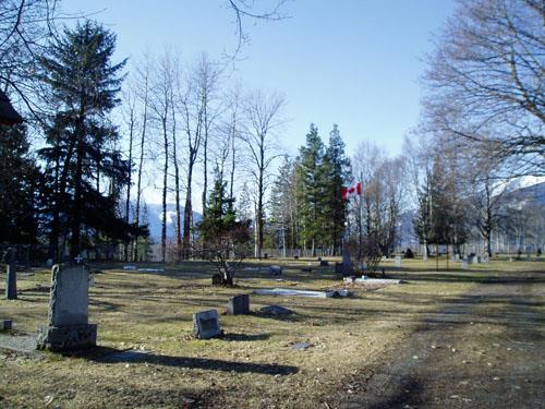 Cemetery in fall with flag pole and veterans area.