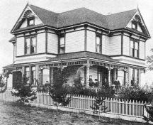 Oblique view showing south and west facades with members of the McRae family, ca. 1895; The McRae Family