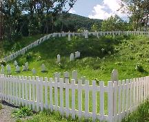 Exterior photo of Old Anglican Cemetery surrounded by a fence, Woody Point, NL.; Town of Woody Point 2005