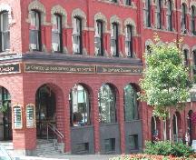 This photograph shows the storefront on King Street and the large Roman arches in relation to the style of the other buildings on this King Street block, 2004; City of Saint John